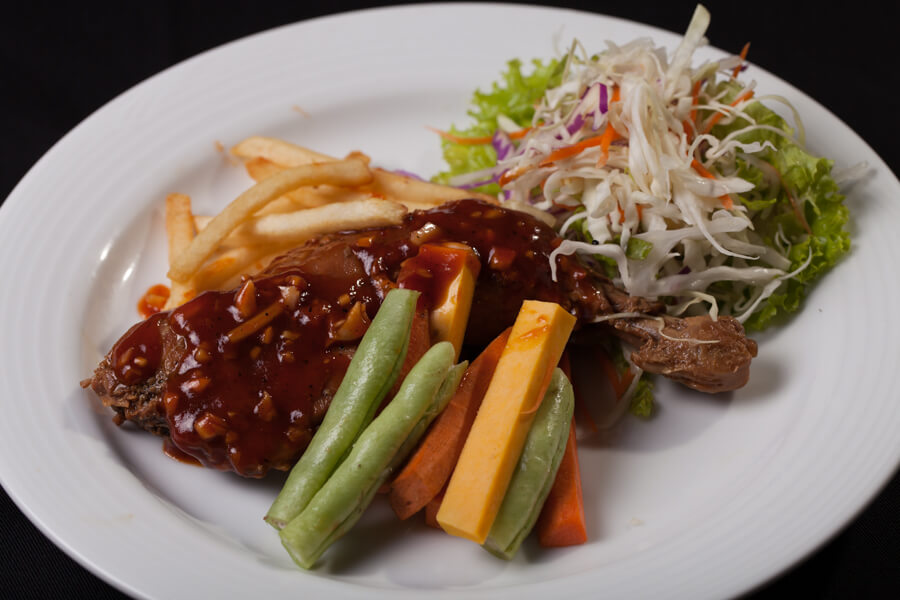 Roasted Chicken with a Side of Salad at Senani Hotel